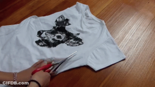 Person Cutting White Shirt With Wolf Picture GIF