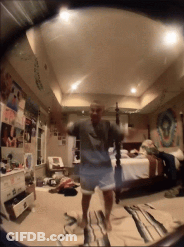 Person Dancing In Bedroom With Bed And Dresser GIF