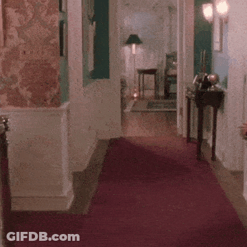 Person Dancing On Red Carpet In Hallway GIF