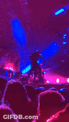 Person Dancing On Stage With Purple Lights GIF