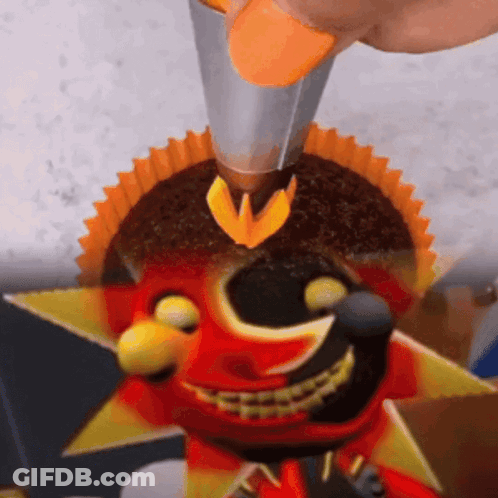 Person Decorating Cupcake With Smiley Face GIF
