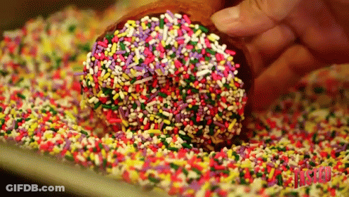 Person Dipping Donut In Sprinkles GIF