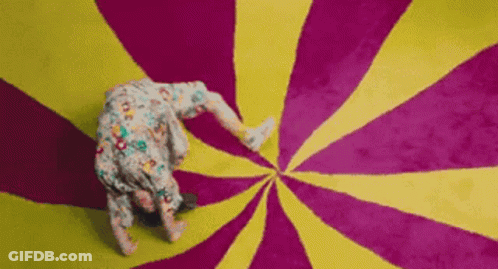 Person Doing Handstand On Colorful Swirl Carpet GIF