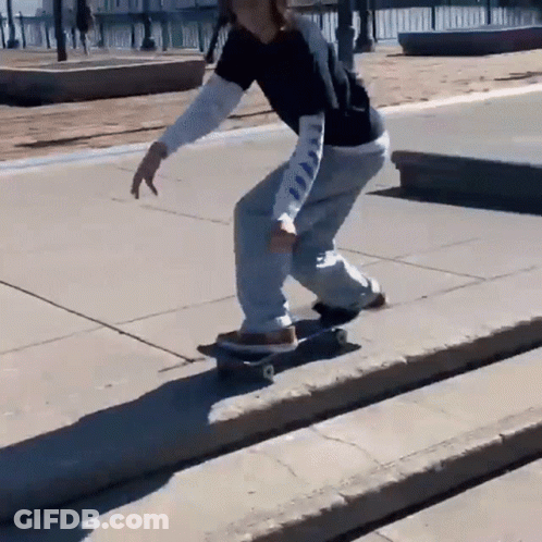 Person Doing Skateboard Trick On Sidewalk GIF