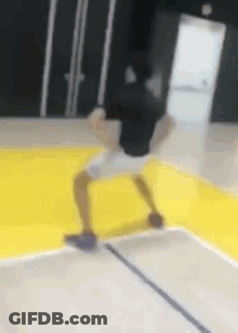 Person Doing Trick On Yellow Basketball Court GIF