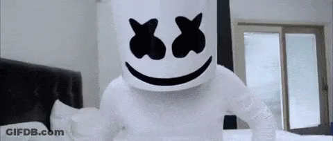 Person Dressed As Marshmello Standing On Bed With Bandaged Arm GIF