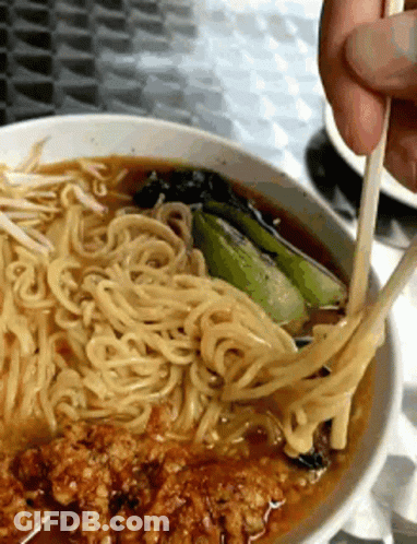 Person Eating Noodles With Chopsticks In Soup Bowl GIF