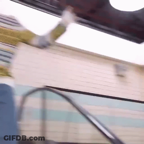Person Falling Down Escalators In Front Of Building GIF