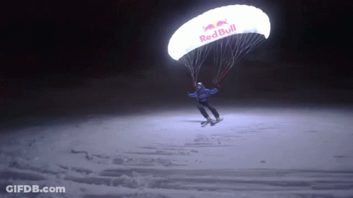 Person Flying Parachute That Says Red Bull GIF