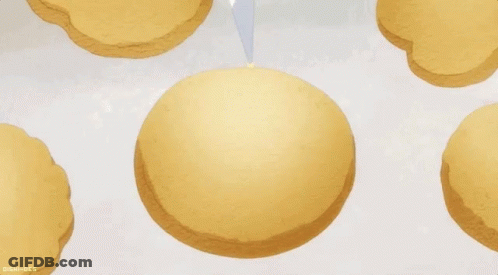 Person Frosting Cookie With White Frosting Bag GIF