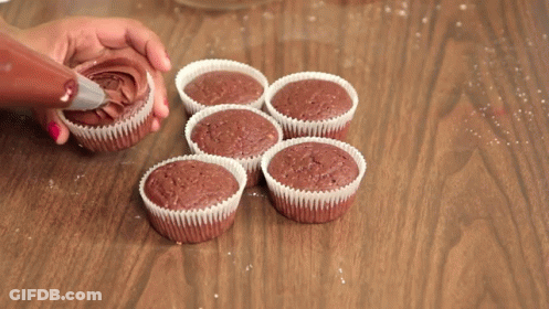 Person Frosting Cupcakes With Chocolate GIF