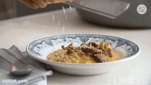 Person Grating Cheese On Plate With Number 52 GIF