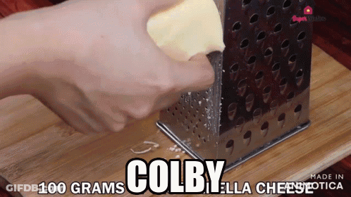 Person Grating Cheese Saying Colby Ella Cheese GIF