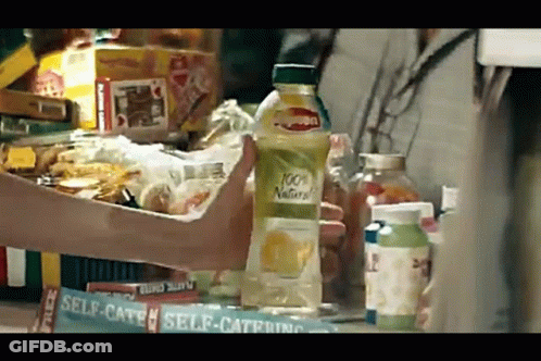 Person Holding 100% Natural Lemon Juice GIF