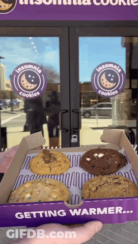 Person Holding A Box Of Insomnia Cookies In Front Of A Store GIF