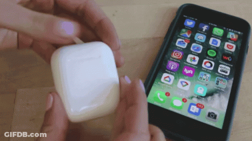 Person Holding Airpod Beside Phone With Apps GIF