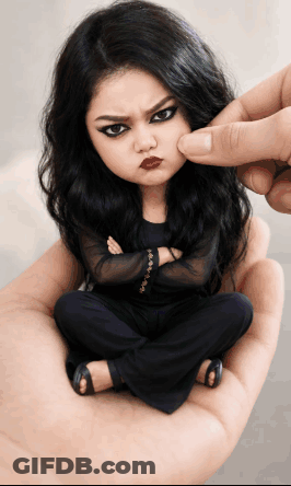 Person Holding Angry Face Doll GIF