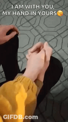 Person Holding Another's Hand Sitting On Tiled Floor GIF