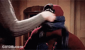 Person Holding Another's Head With Scarf Around Mouth GIF