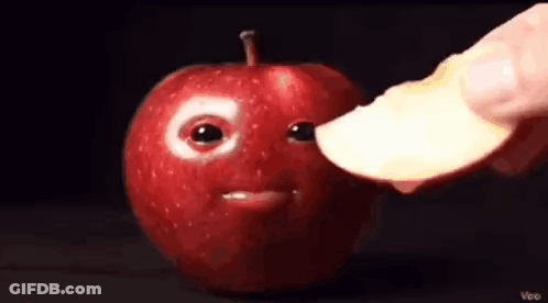 Person Holding Apple Slice Near Apple Face GIF