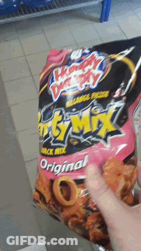 Person Holding Bag Of Chunky Monkey Snack Mix Original GIF