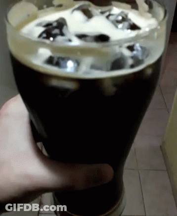 Person Holding Beer Glass With Ice Cubes GIF