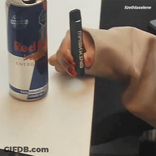 Person Holding Black King Device Next To Red Bull Can GIF