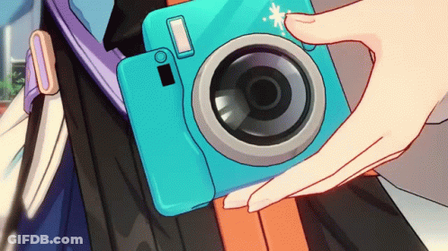 Person Holding Blue Camera With White Circle On Lens GIF