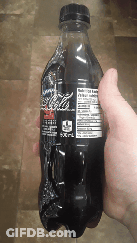Person Holding Bottle Of Oreo Flavored Coke GIF