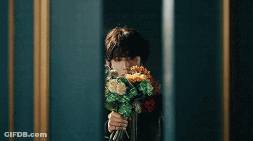 Person Holding Bouquet Of Flowers In Front Of Mirror GIF