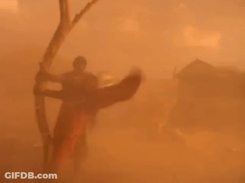 Person Holding Bow And Arrow In Desert GIF