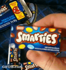 Person Holding Box Of Smarties Candy GIF