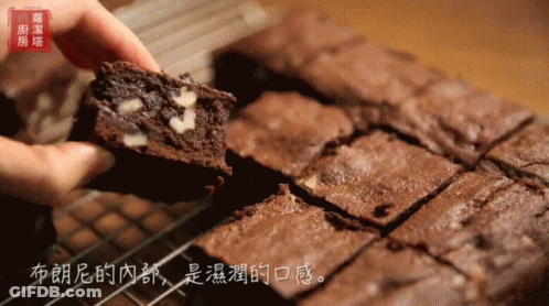 Person Holding Brownie With Chinese Writing GIF
