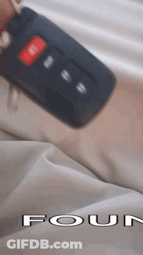 Person Holding Car Key In Front Of Four Logo GIF