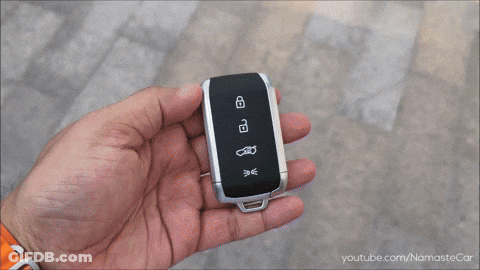 Person Holding Car Key With Namastecar URL GIF
