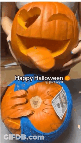 Person Holding Carved Pumpkin Saying Happy Halloween GIF