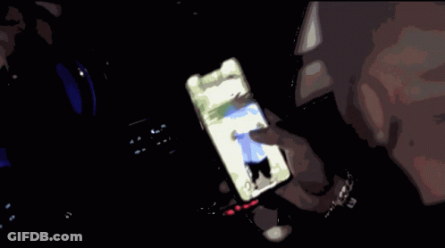 Person Holding Cell Phone With Man On Screen GIF