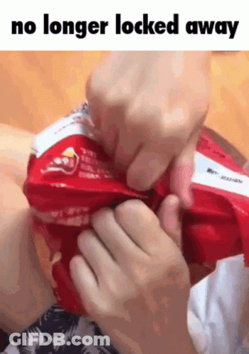 Person Holding Chips Saying No Longer Locked Away GIF