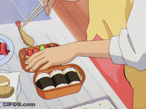 Person Holding Chopsticks Over Bento Box GIF