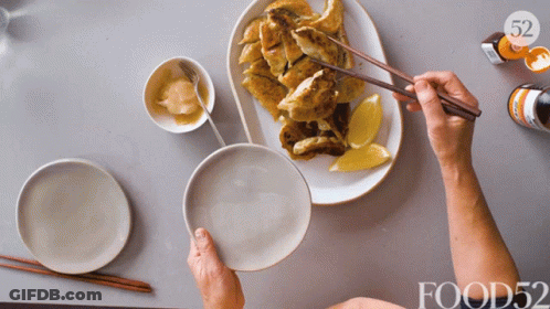 Person Holding Chopsticks Over Plate Of Food 52 GIF