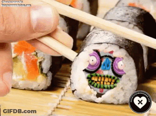 Person Holding Chopsticks Over Sushi With Face GIF