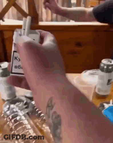 Person Holding Cigarettes GIF