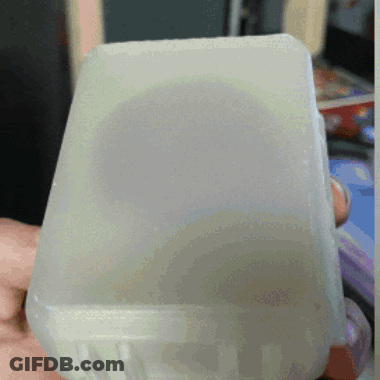 Person Holding Clear Plastic Container With White Lid GIF