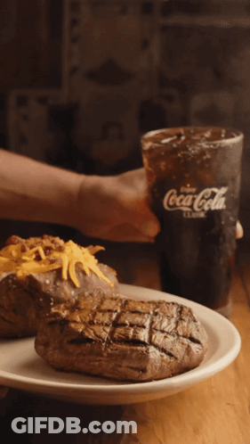 Person Holding Coca-Cola Next To Plate Of Food GIF