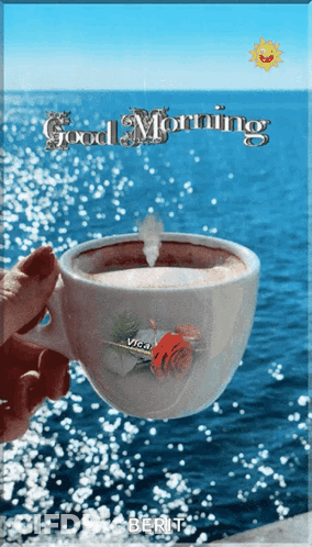 Person Holding Coffee In Front Of Ocean GIF