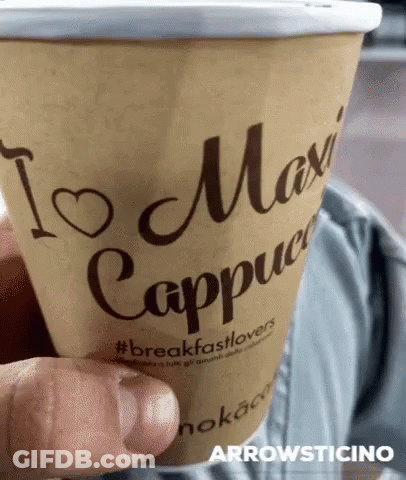 Person Holding Coffee In Front Of Samsung Screen GIF