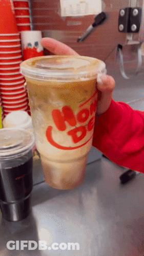 Person Holding Cup Of Hot Dog GIF