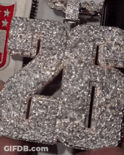 Person Holding Diamond Number 26 Necklace GIF