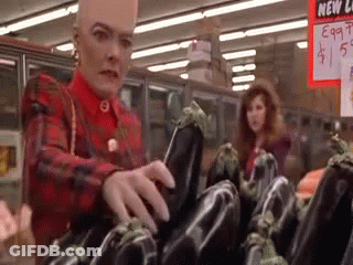 Person Holding Eggplant Over Red Bowl Of Water GIF