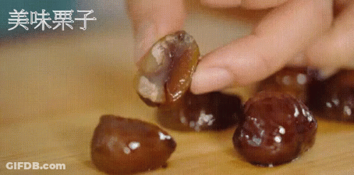 Person Holding Food With Chinese Writing GIF